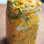 jar full of curried red lentil and spinach stew