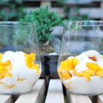 2 cups piled with chopped mango and coconut cream