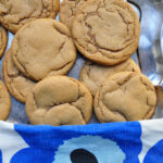 soft nutmeg cookies on a silver tray with blue flower dish towel