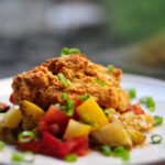 zucchini and tomato savory summer cobbler on a white plate