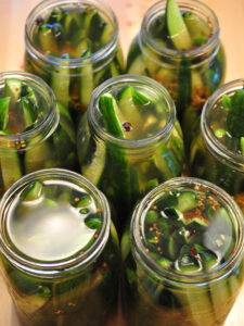 pickles with brine poured over them before lids go on.