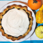 Pumpkin pie with a side of decorative gourds