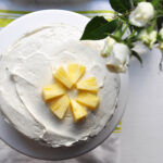 Carrot-pineapple cake with cream cheese frosting from the top with flowers