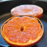 close up of half a grapefruit with slightly blackened edges