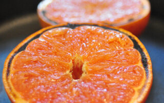 close up of half a grapefruit with slightly blackened edges