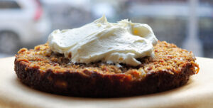 Layer of carrot-pineapple cake with frosting piled on top