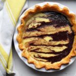 coconut chocolate swirl pie in dish with yellow dish cloth beside