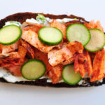 pumpernickel bread with smoked paprika rubbed salmon, cucumbers and dill cream cheese